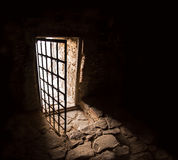 ancient-door-dark-room-arc-fort-passageway-cold-damp-blackness-to-glow-light-rusted-iron-grate-cell-gaol-rugged-90283510